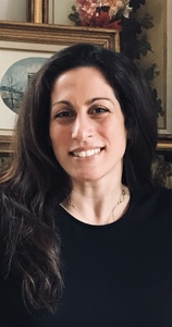 Headshot of Karian Markos from shoulders up smiling.