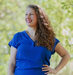 Britta sideways shot with long curly brown hair