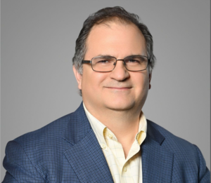 <img src="RJK Photo 2024.png" alt="A beautiful portrait of Robert J. Khoury wearing a blue blazer, bright beige shirt">