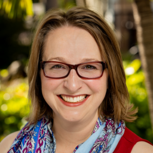Naomi Rawlings smiling in a red dress