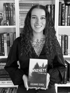 Julianne Feher holding a copy of Childless