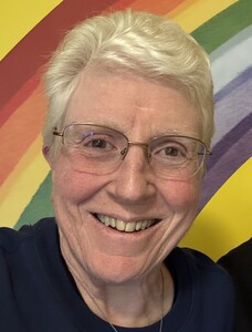 Annette Marquis portrait with rainbow background
